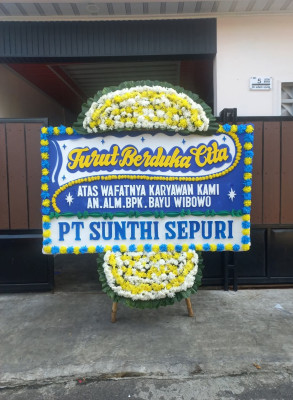 Papan Bunga Duka di Tanah Baru