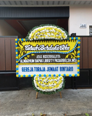 Papan Bunga Duka di Tanah Baru